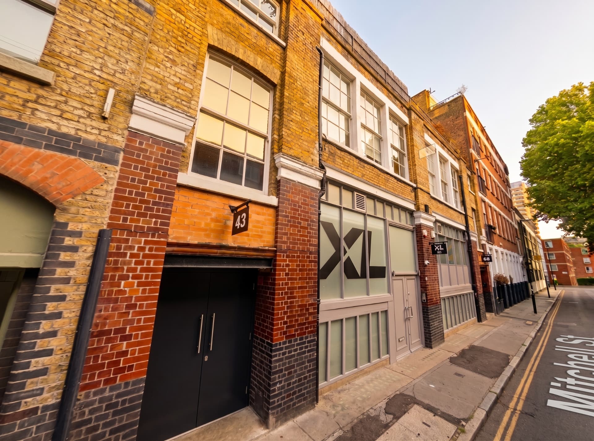 Brick frontage of 43-45 Mitchell Street, London EC1, at golden hour